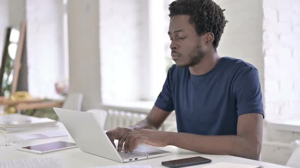 Sick African Man Coughing in Modern Office