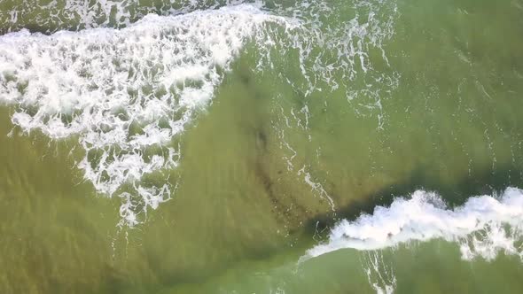 Top View of the Foaming Turquoise Waves. Aerial Survey