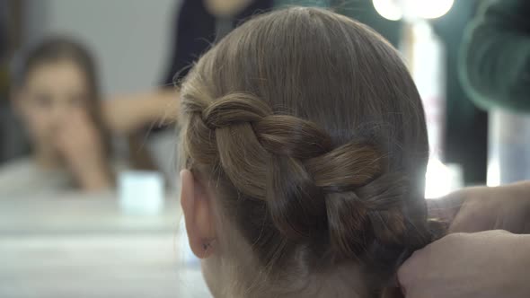 Hairdresser Makes Pigtails To a Girl