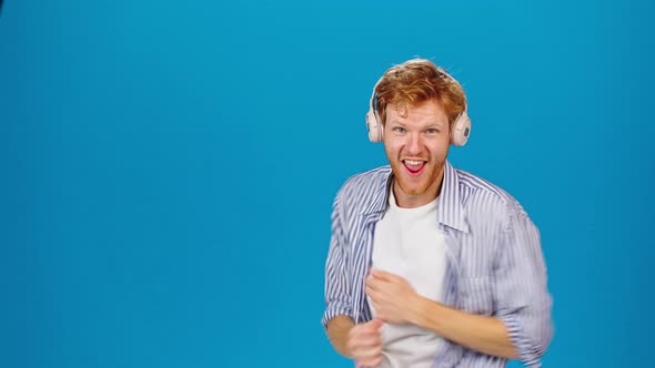 Cheerful Man in Headphones Enjoys Dancing to Favorite Song