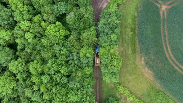 Aerial view of farming tractor crop sprayer in the countryside