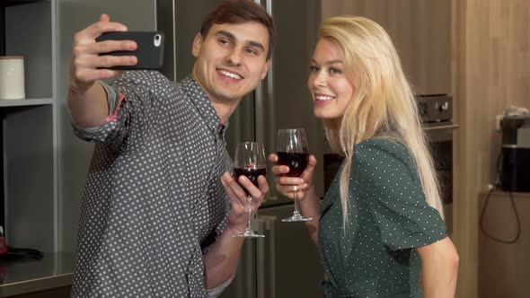 Young Happy Couple Taking Selfies with Smart Phone, Celebrating Valentines Day