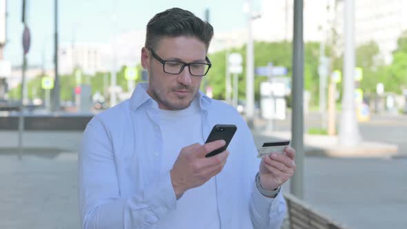 Excited Man Shopping Online Via Smartphone Outdoor