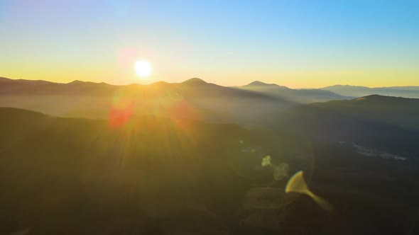 Beautiful Mountain Panoramic Landscape with Hazy Peaks and Foggy Valley at Sunset