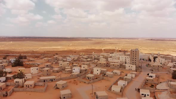 aerial shot of an old empty city in the desert in palestine near Gaza at morning with beautiful clou