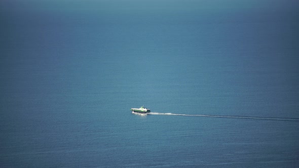 A Highspeed Ship on the Underwater Wings with Tourists at Full Sail in the Calm Sea