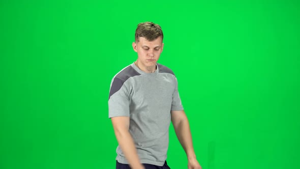 Guy Goes and Dances, Smiles and Rejoices on a Green Screen, Chroma Key. Side View