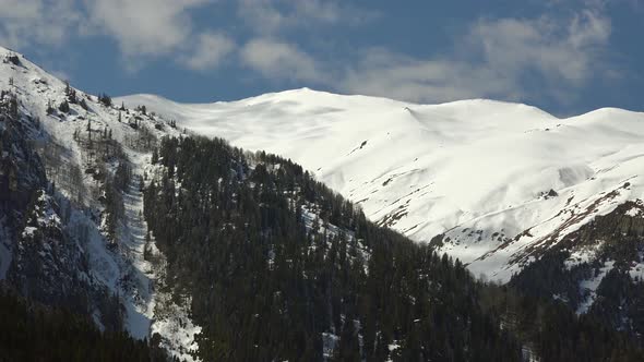 Soft Curved Mountain Ridge and Snowy Peaks in Winter