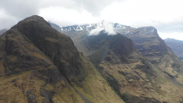 Aerial view of  highlands in Scotland, with clouds over the famous mountains