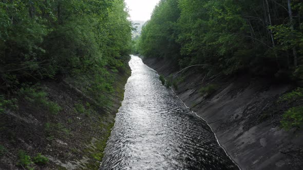 Drone View of an Artificial Canal in a Green Forest