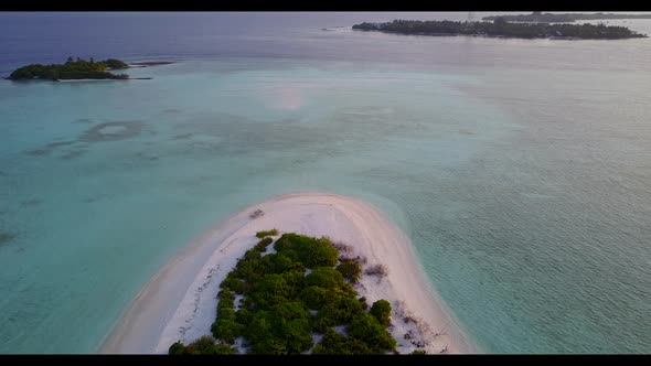 Aerial drone view seascape of tranquil coast beach trip by shallow sea with white sandy background o