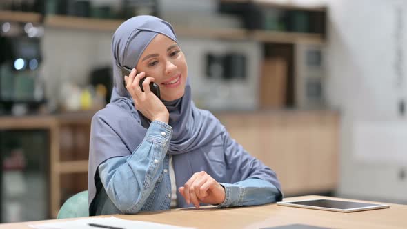 Professional Arab Woman Talking on Smartphone at Work