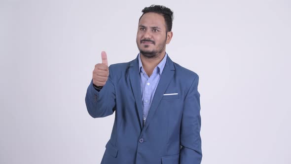 Happy Bearded Indian Businessman Giving Thumbs Up