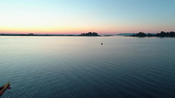 Aerial Drone Footage. Tourists Are Kayaking. Beautiful Sunrise Over River