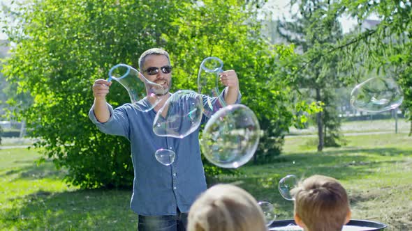 Smiling Performer Making Soap Bubbles in Park