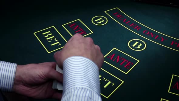 Croupier Makes Fan in Hands Under Poker Table, Slow Motion