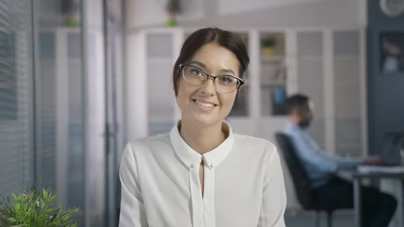 Cute Sexy Woman with Beautiful Style in Glasses in Office Place Look and Smile