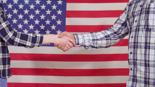 Close Up of a Handshake on the Background of the USA Flag
