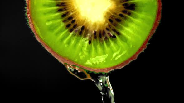 Super Slow Motion with a Round Piece of Kiwi Escapes the Water