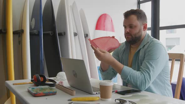 Male surfboard maker in his workshop