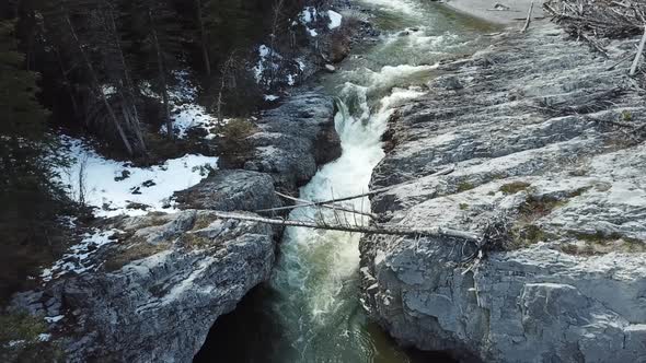 Aerial Footage Of Creek Flowing Between Small Cliffs