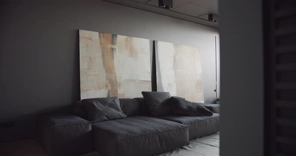 The Modern Minimalist Living Room with Black and Gray Tone Large Paintings