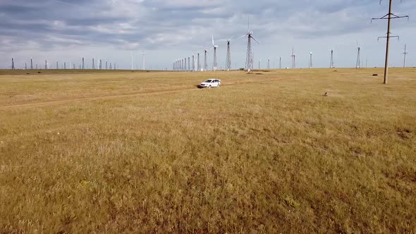 Aerial View of Wind Farms in the Field Rotating Blades