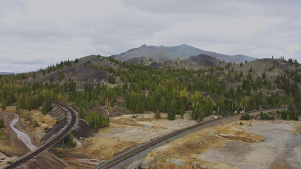 A Mountain of Industrial Waste on a Background of Sandy Ground