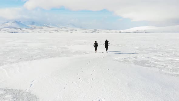 Mother And Son Plays Running In Winter Landscape