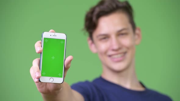 Young Handsome Teenage Boy Showing Phone