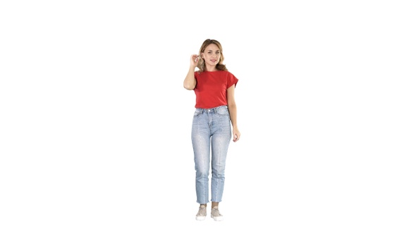 Blonde woman preening on white background.