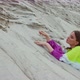 Beautiful Girl Lying on Sandy Dune Looking at the Camera with Passionate Look Slow Motion Video - VideoHive Item for Sale