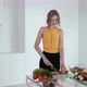 Young Woman Slicing Red Pepper For Vegetable Salad. White Modern Kitchen. - VideoHive Item for Sale