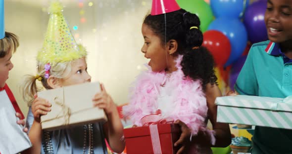 Kids holding gift boxes during birthday party 4k