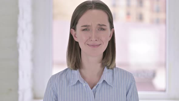 Portrait of Crying Young Woman Looking at the Camera