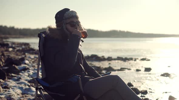 Man Warming Hands Steaming Cup Of Mate Tea. Male Hands With Mug Of Hot Drink Cold Winter Outdoors.