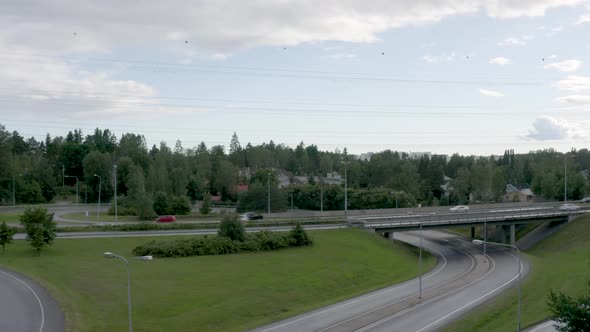 Slow aerial pan of cars passing quickly on a motorway in Finland near Helsinki.