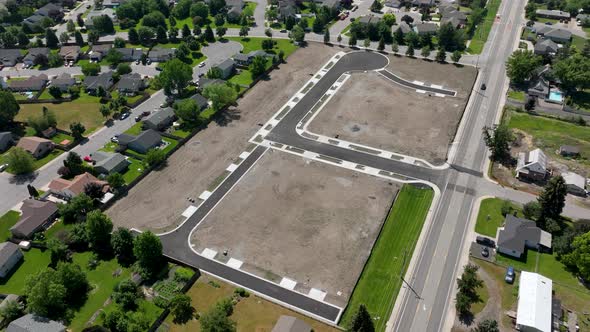 Aerial over a paved neighborhood prior to construction.