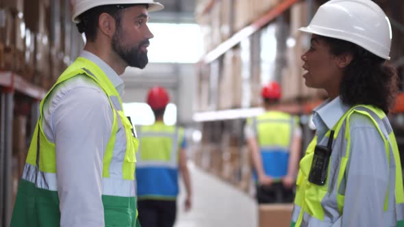 Meeting of Two Logistics Managers in Warehouse