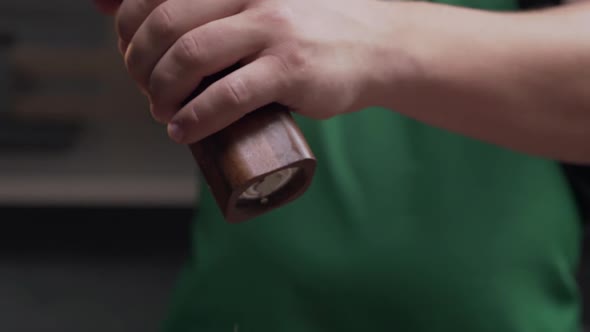 Macro Shot: Chef Uses Salt Mill To Add Some Salt for His Meal, Salt Falls in Slow Motion, Milling