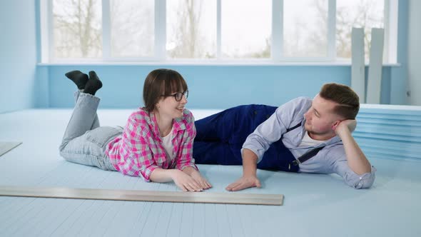 Married Couple Man and Wife Enjoy an Insulated Polystyrene Foam Floor Before Laying Laminate