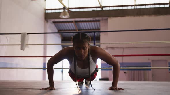 Mixed race woman working out in boxing gym