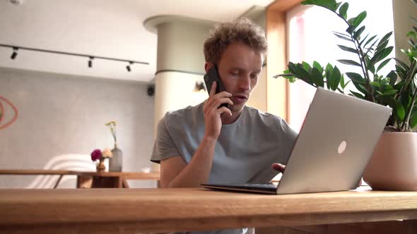 Nice, young man working on a laptop indoors.