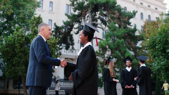 College Principal Giving the Diploma to One of the