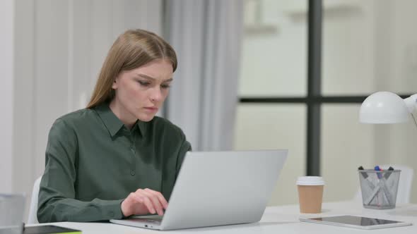Young Woman with Laptop Having Loss, Failure 
