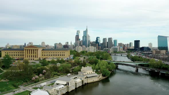 Drone Aerial rising above Philadelphia city skyline showing Comcast Technology Center, Art Museum, a
