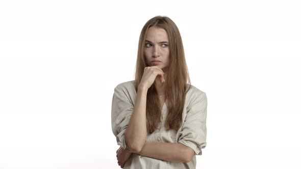 Video of Thoughtful Blond Woman in Casual Blouse Thinking and Trying Figure Something Out Shrugging