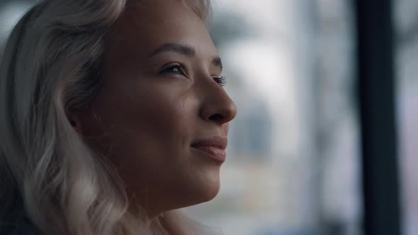 Caucasian Female Face Looking Away with Blond Hair in Blurred Background City