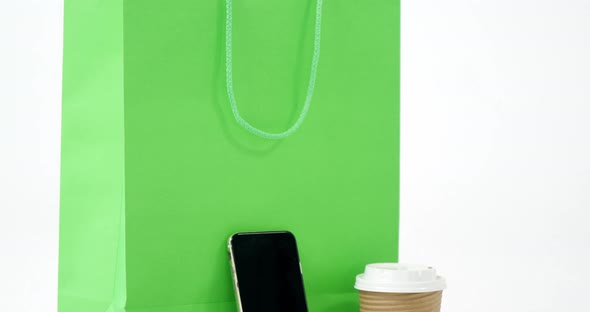 Shopping bag, mobile phone, sunglass and coffee