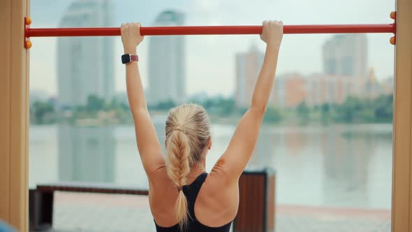 Fitness Exercising On Pull-ups Bar. Woman Pulling Up In Gym.Fit Woman Workout Exercise.